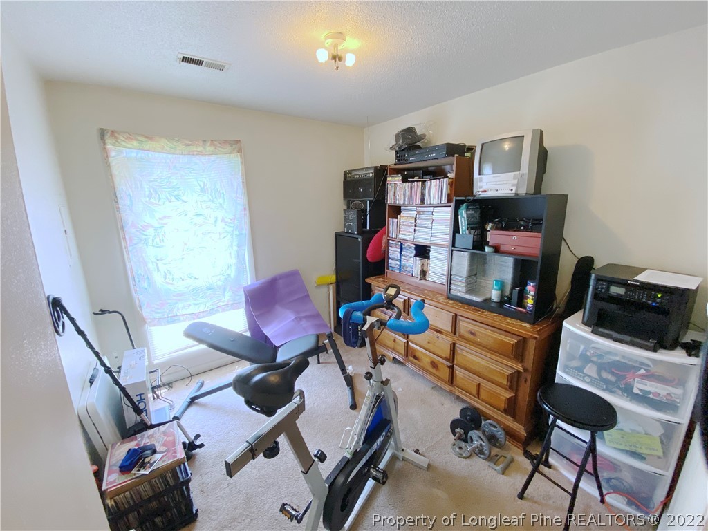 1815 Rivergate Road Fayetteville, NC 28304 - Photo 7 of 14 a room with furniture and a wooden floor