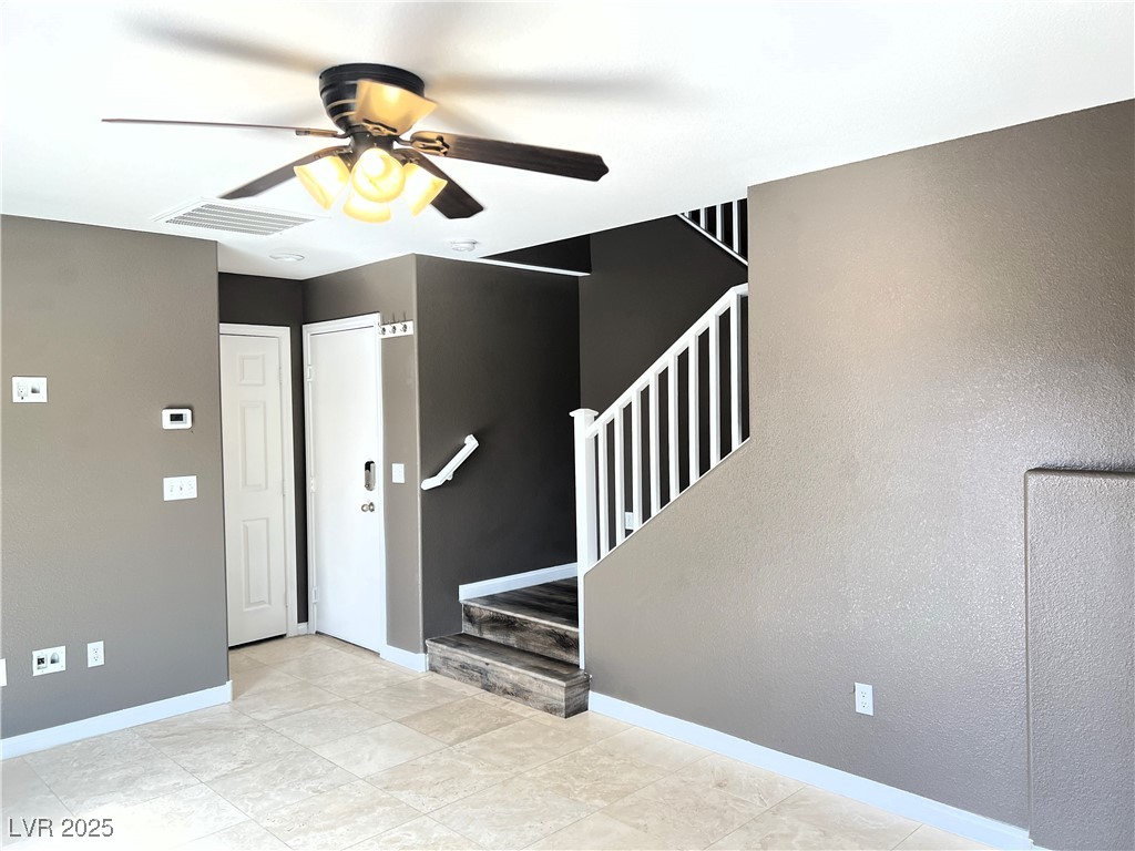 9535 Leaping Lizard Street Las Vegas, NV 89178 - Photo 14 of 37 Downstairs living room with wall mount TV hookups, celing fan, full bath and garage door access