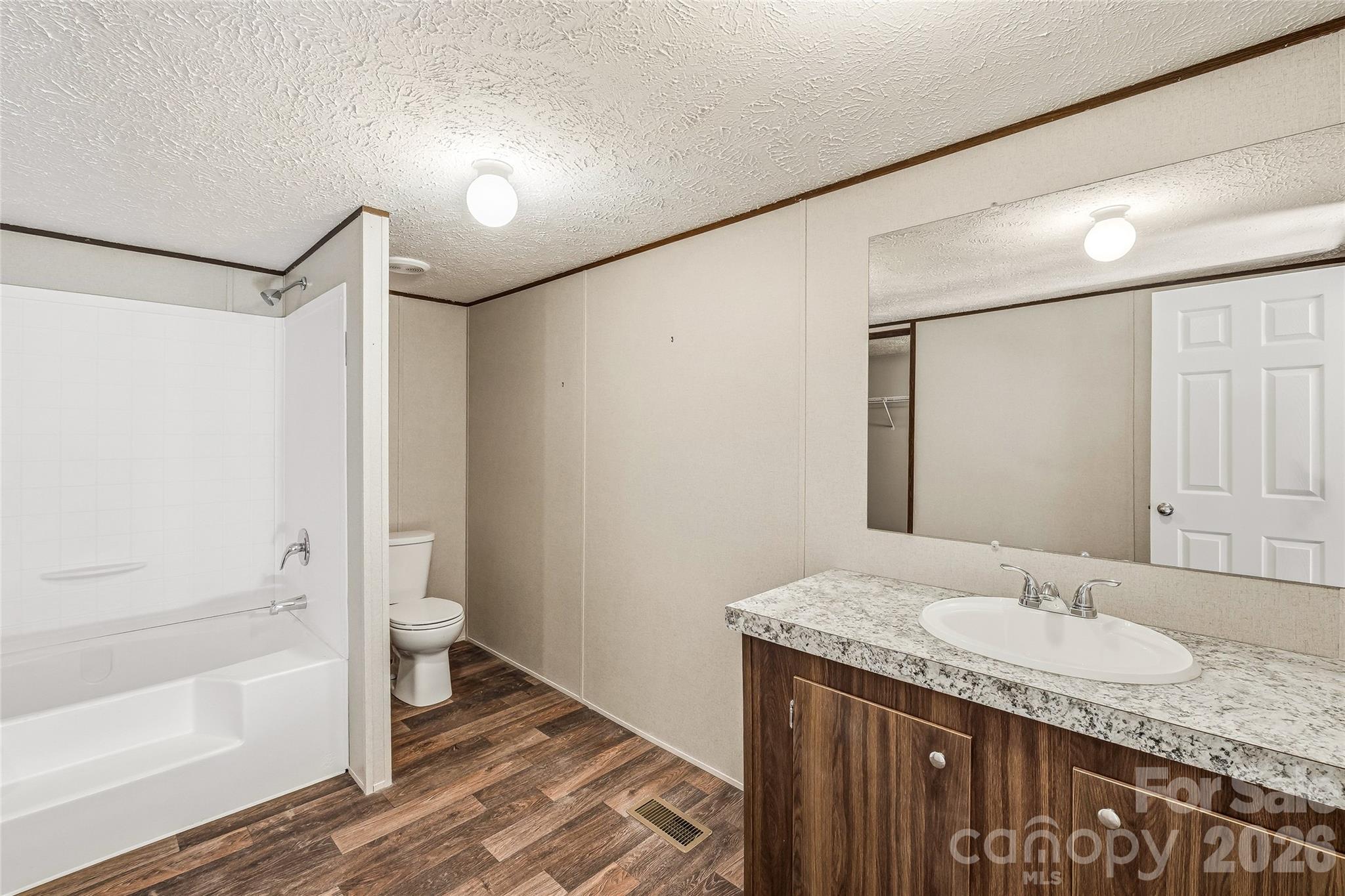 45 Alan Retreat Road Hendersonville, NC 28792 - Photo 19 of 25 a bathroom with a granite countertop sink toilet and shower