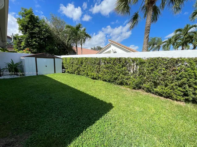 a view of a backyard with sitting area