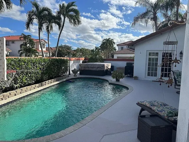 a view of backyard of house with outdoor seating