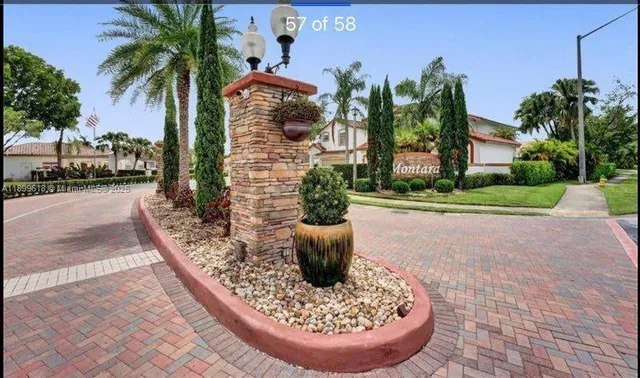 a sign of golf club on a wall under a tree