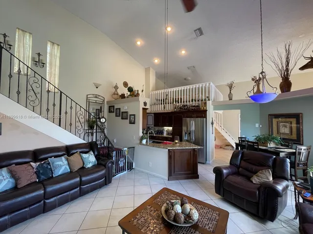 a living room with furniture a dining table and a fireplace
