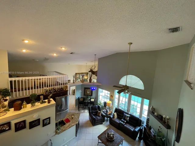 a kitchen with granite countertop a sink stove and cabinets