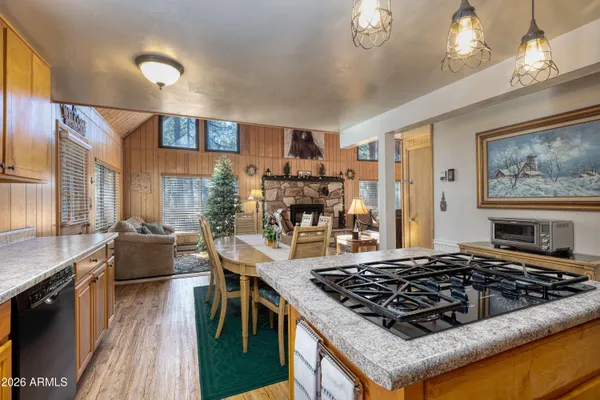 a kitchen with stove and wooden floor