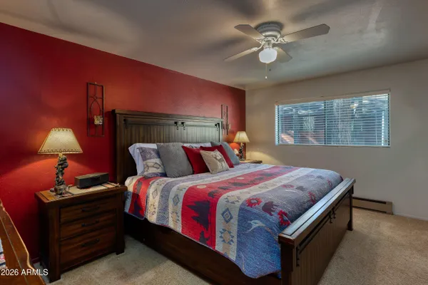 a bed sitting in a bedroom next to a lamp