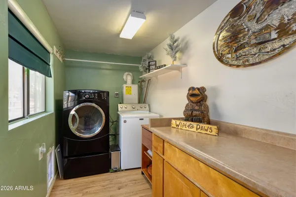 a view of a storage and utility room with a washer dryer
