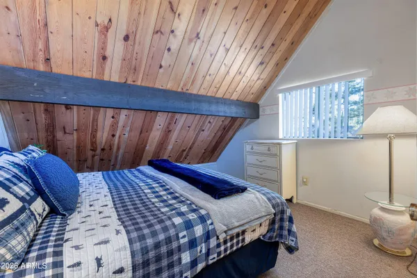 a bedroom with bed and a window