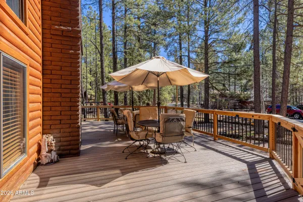 a view of backyard with outdoor seating and wooden floor