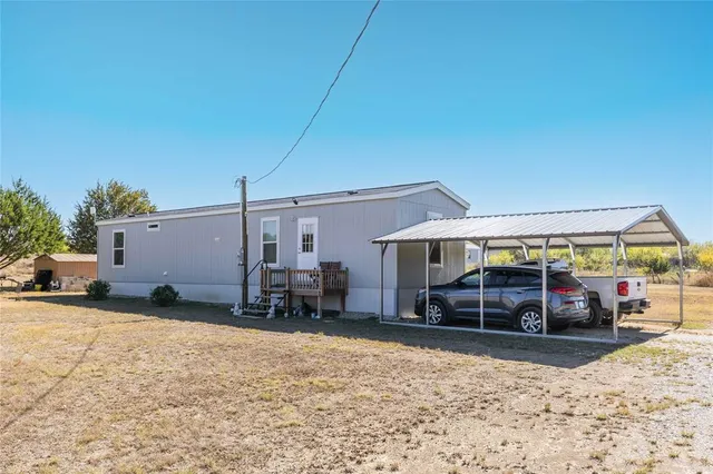 a view of a house with a yard covered in snow