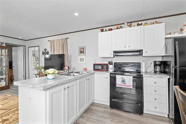 a kitchen with appliances cabinets and furniture