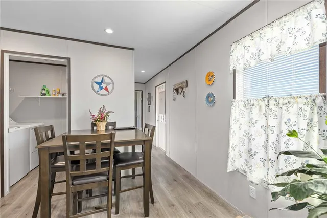 a view of a dining room with furniture and a large window