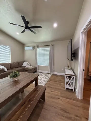 a bedroom with furniture and a wooden floor