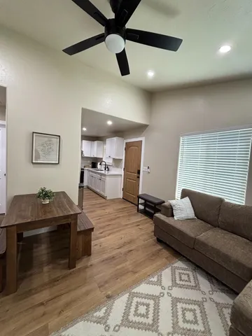 a living room with furniture and kitchen view