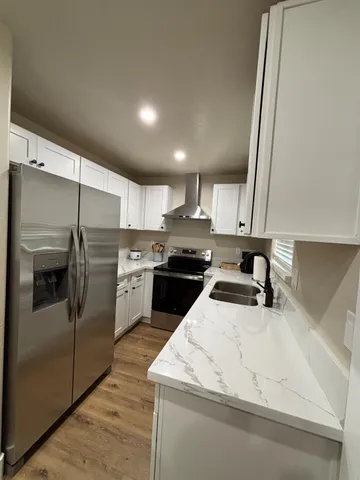 a kitchen with a sink a stove and refrigerator