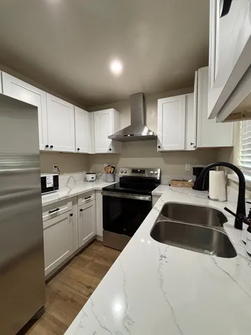 a kitchen with a sink a stove and cabinets