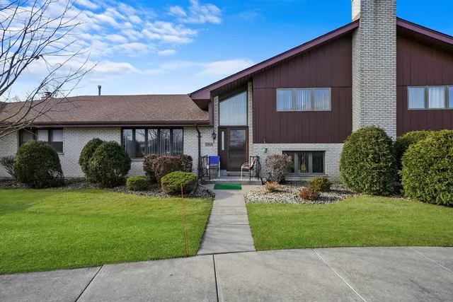 a front view of a house with garden and porch