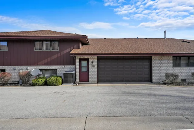 an aerial view of a house with a garden and lake view