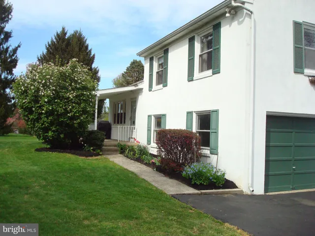 a front view of a house with a yard and porch