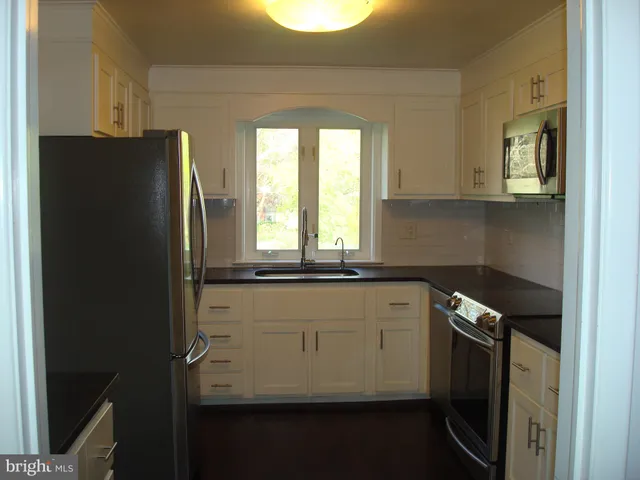 a kitchen with appliances and cabinets