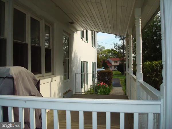 a view of a hallway with wooden floor and stairs