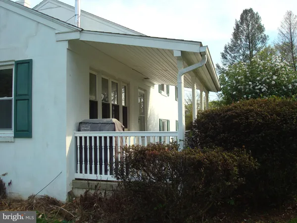 a living room with wooden floor a fireplace and a window