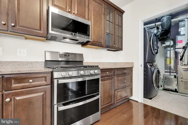 a kitchen with stainless steel appliances a stove microwave and sink