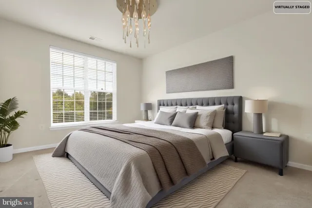 a view of an empty walk in closet with wooden floor