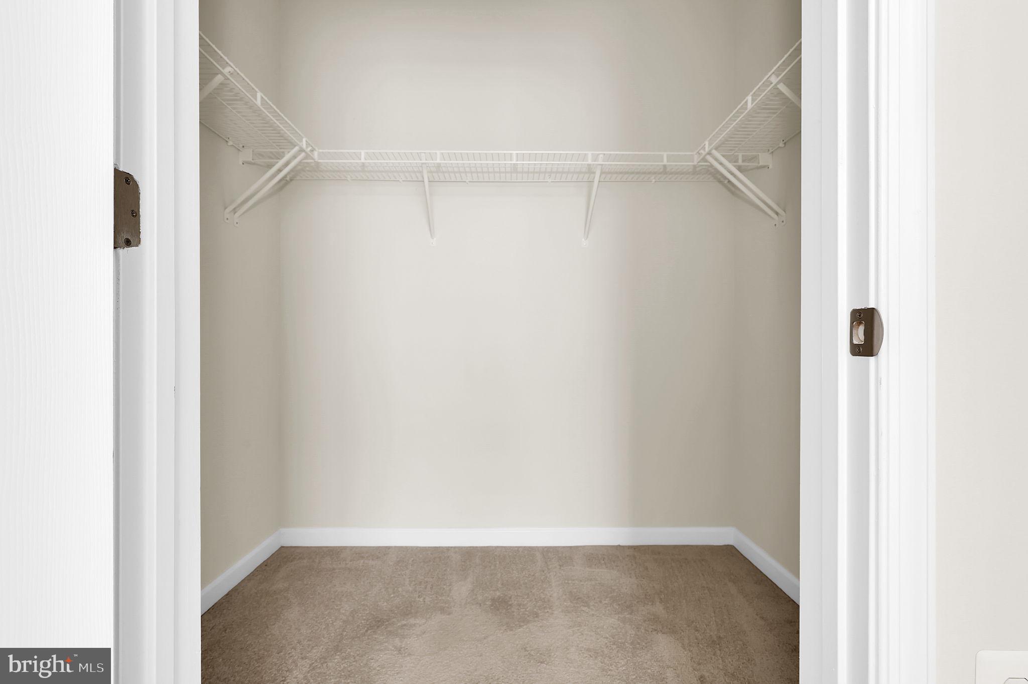 3750 Clara Downey Avenue, Unit 34 Silver Spring, MD 20906 - Photo 17 of 25 a view of an empty walk in closet with wooden floor