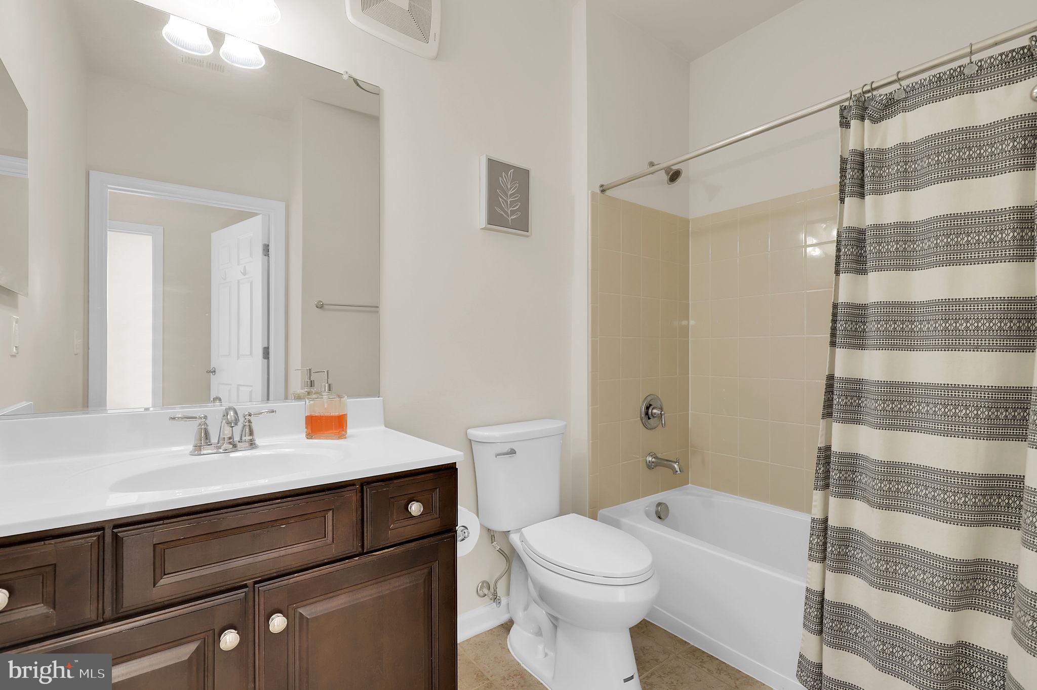 3750 Clara Downey Avenue, Unit 34 Silver Spring, MD 20906 - Photo 21 of 25 a bathroom with a sink a toilet a shower and a mirror