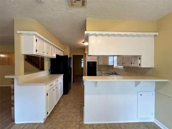 a kitchen with stainless steel appliances granite countertop a stove and a refrigerator