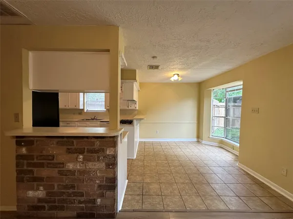 a view of kitchen with granite countertop cabinets and outdoor space