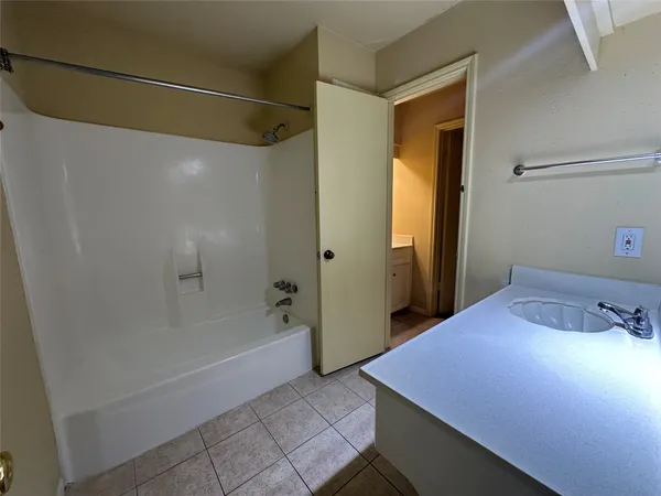 a bathroom with a bathtub and shower