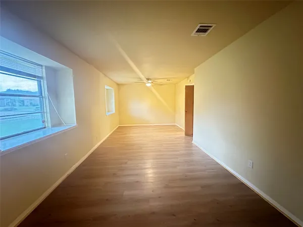 a view of hallway with stairs and wooden floor