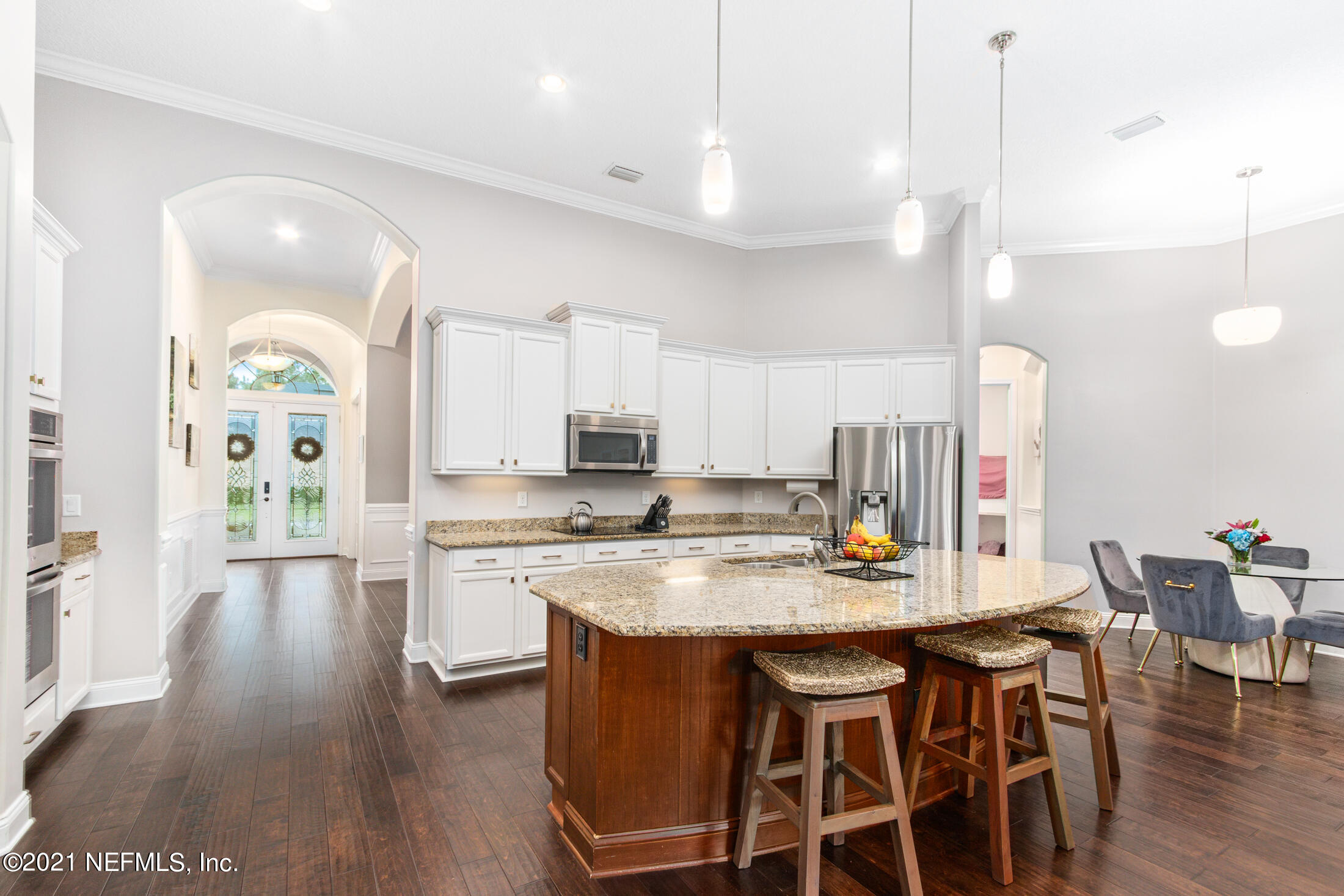 198 Glen Laurel Drive St. Johns, FL 32259 - Photo 12 of 51 a kitchen with a dining table chairs wooden floor appliances and cabinets
