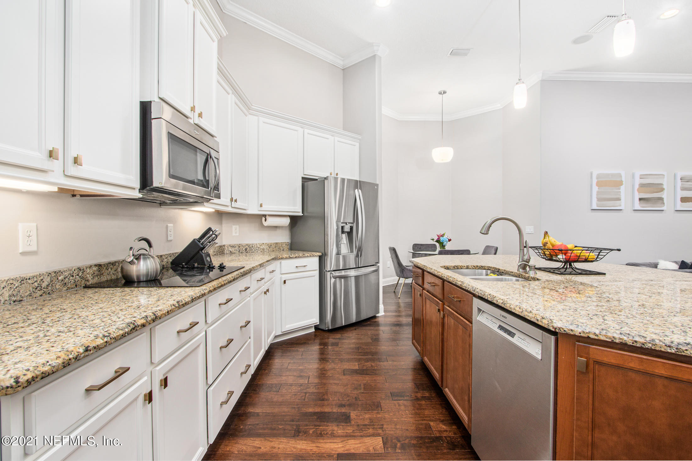 198 Glen Laurel Drive St. Johns, FL 32259 - Photo 14 of 51 a kitchen with granite countertop stainless steel appliances a sink dishwasher a refrigerator oven and white cabinets