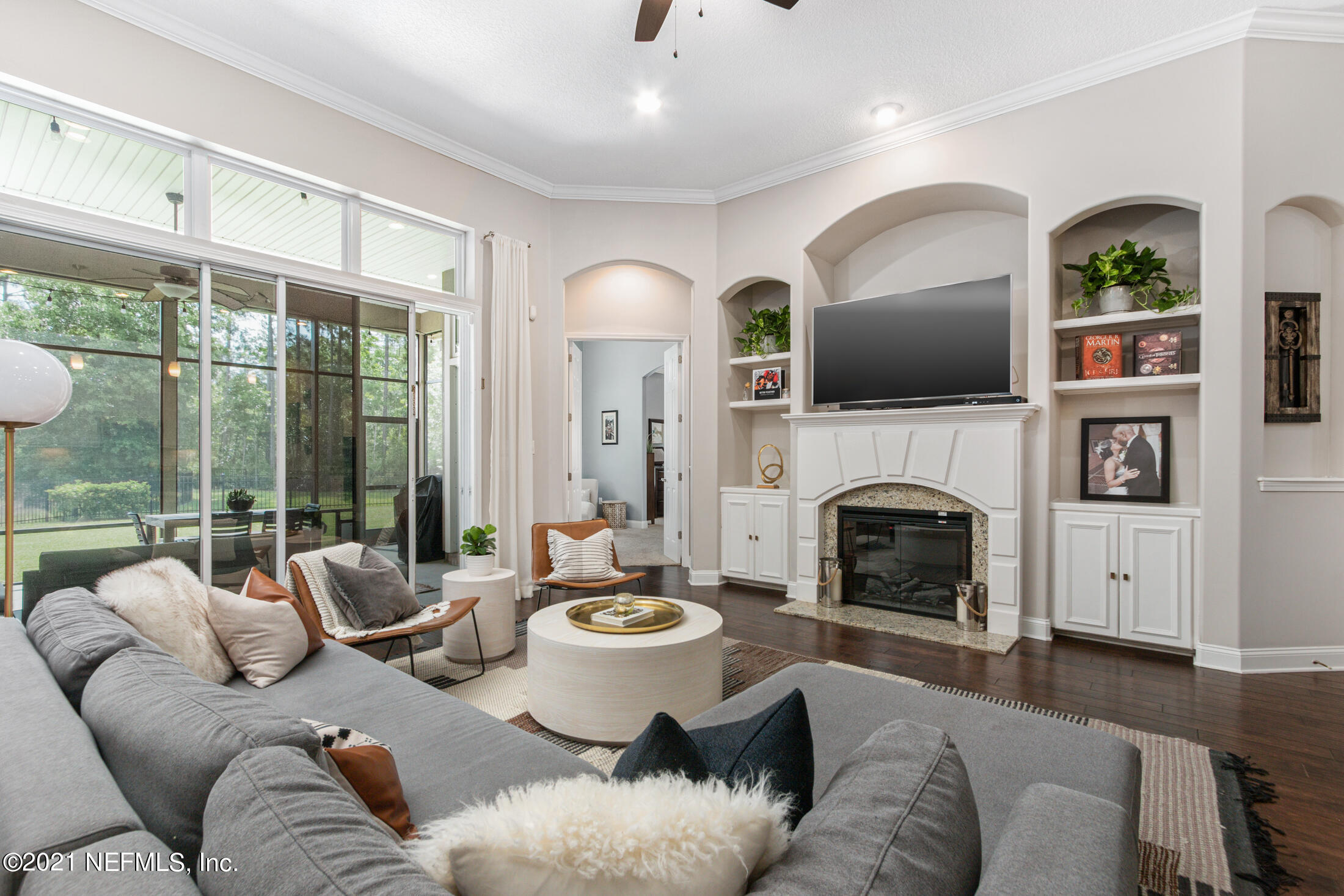198 Glen Laurel Drive St. Johns, FL 32259 - Photo 19 of 51 a living room with furniture a fireplace and a floor to ceiling window