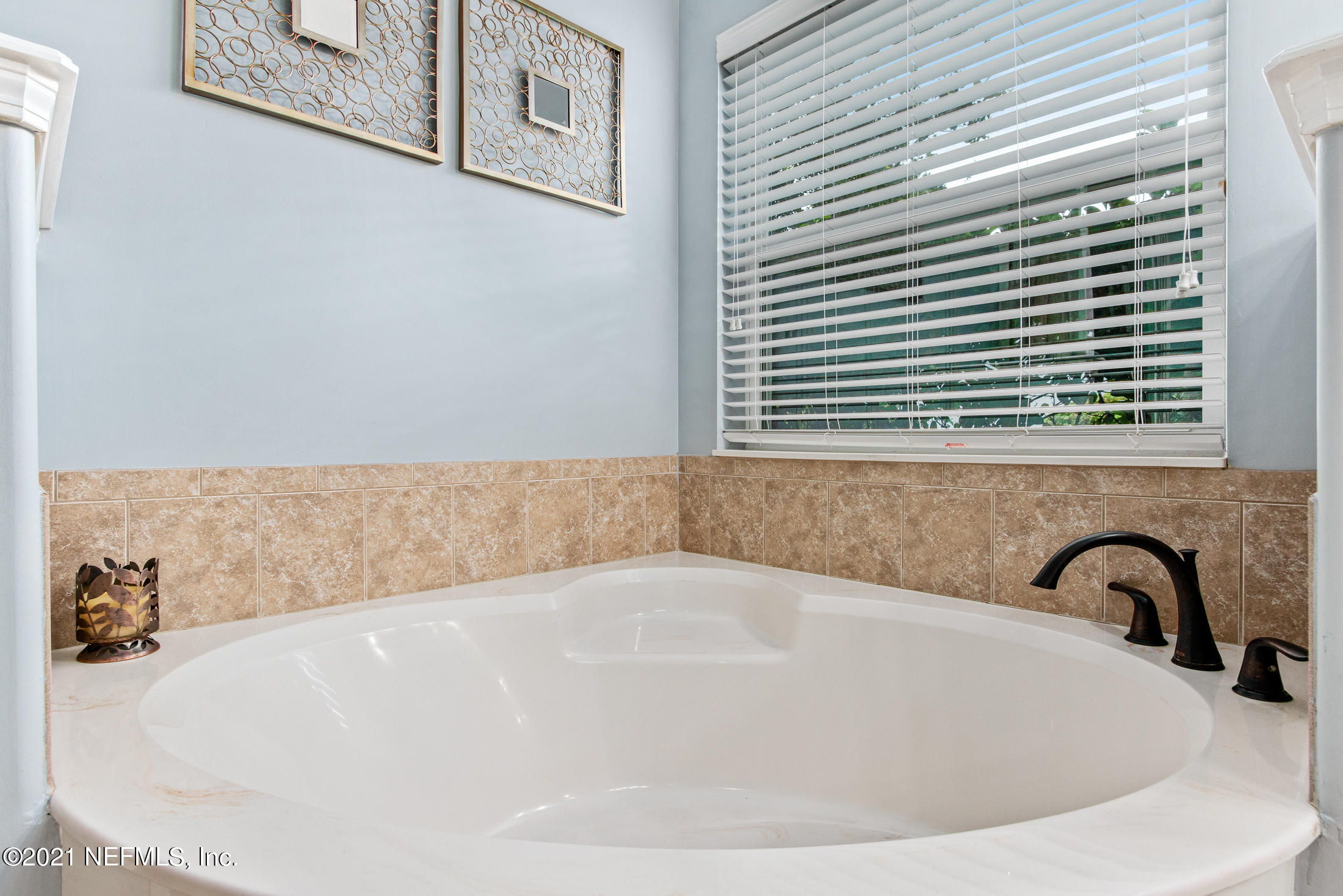 198 Glen Laurel Drive St. Johns, FL 32259 - Photo 28 of 51 a white bath tub sitting in a bathroom next to a window