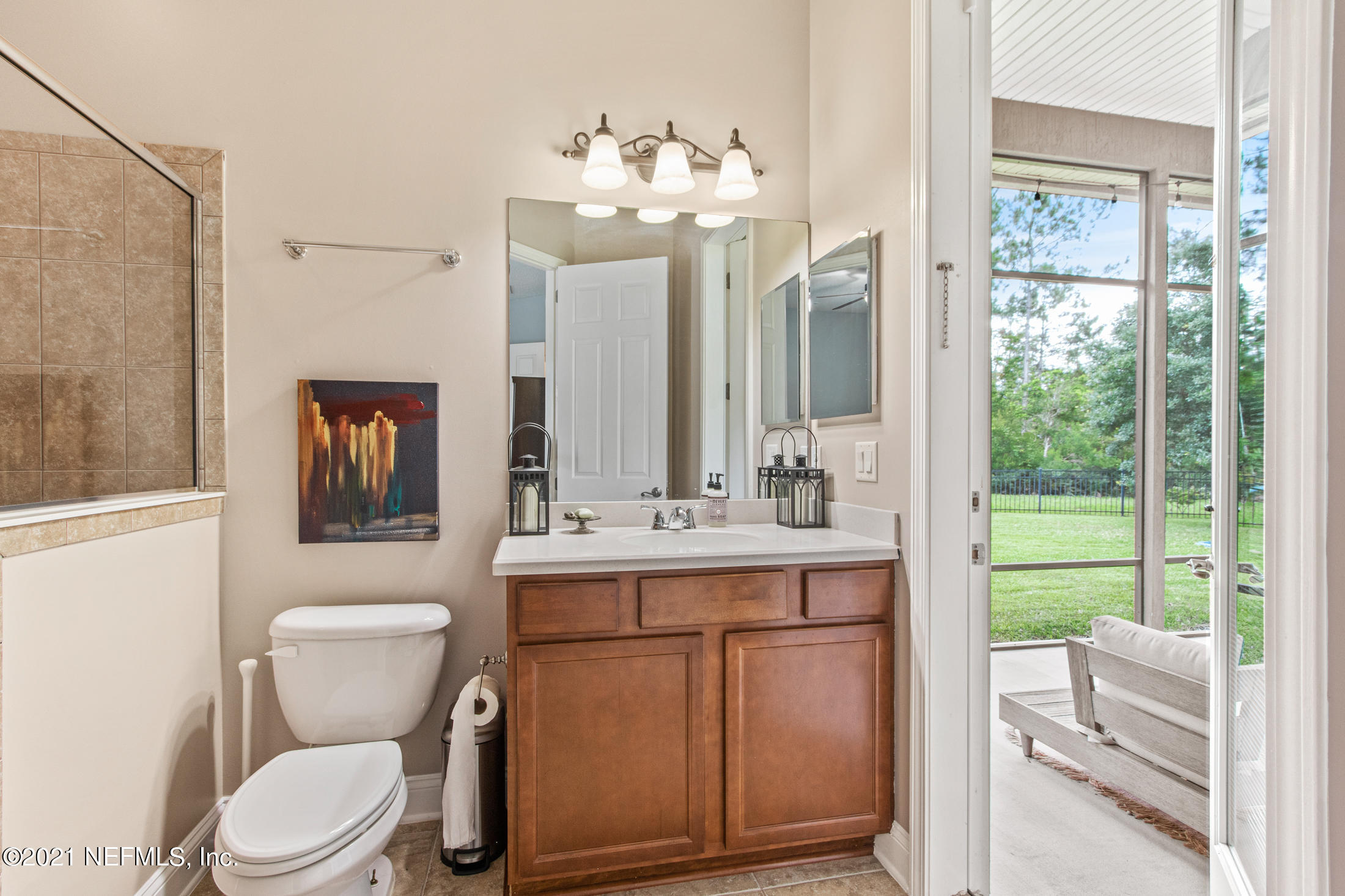 198 Glen Laurel Drive St. Johns, FL 32259 - Photo 34 of 51 a bathroom with a toilet a sink a mirror a window and vanity