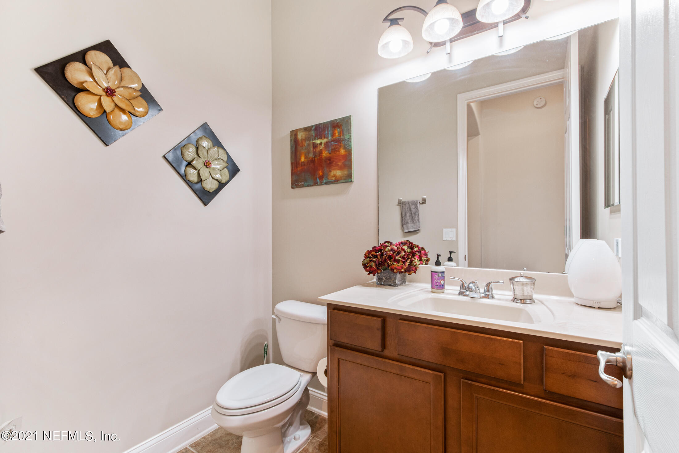 198 Glen Laurel Drive St. Johns, FL 32259 - Photo 38 of 51 a bathroom with a toilet a sink and mirror