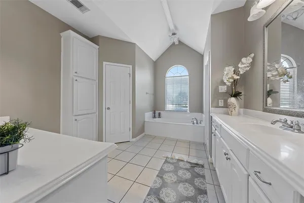 a spacious bathroom with a granite countertop sink mirror and