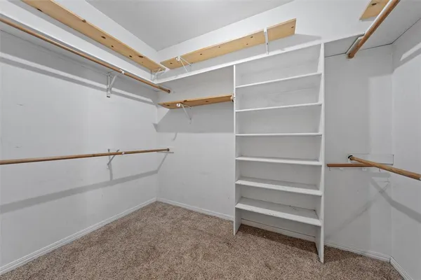a view of an empty room with a ceiling fan