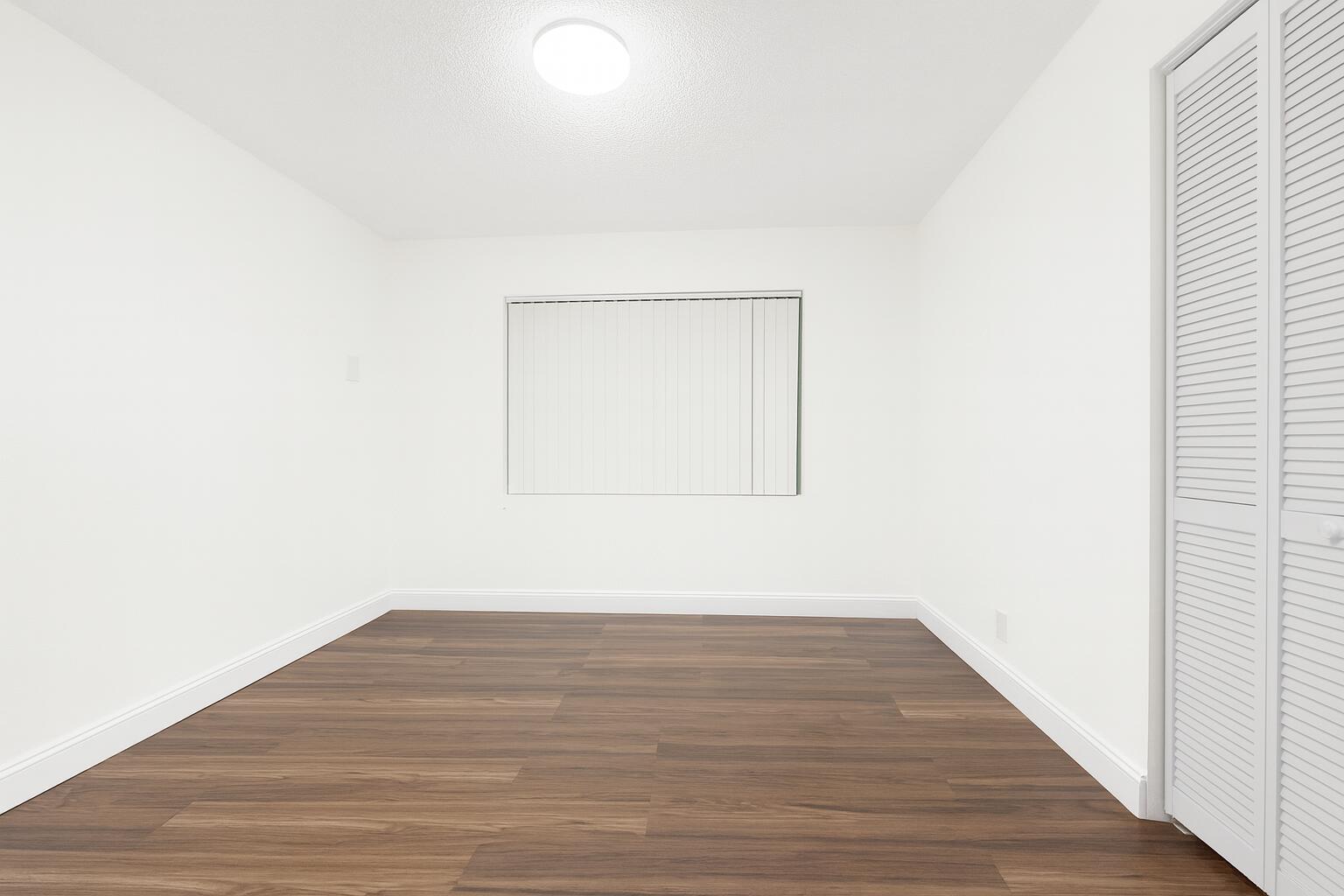1027 Beech Road West Palm Beach, FL 33409 - Photo 9 of 13 a view of an empty room with wooden floor