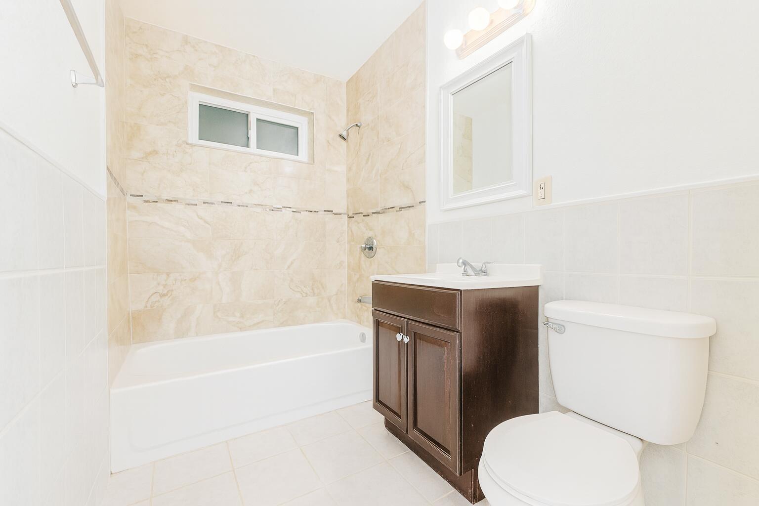 1027 Beech Road West Palm Beach, FL 33409 - Photo 10 of 13 a bathroom with a sink a toilet and bathtub
