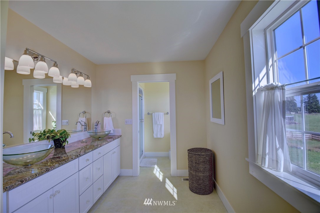 17012 Kaylen Lane Southwest Rochester, WA 98579 - Photo 12 of 26 a bathroom with a granite countertop sink a toilet and a mirror