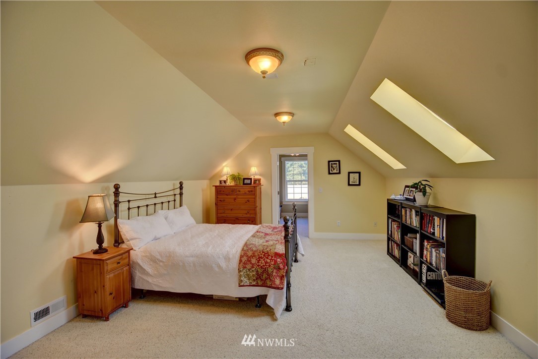 17012 Kaylen Lane Southwest Rochester, WA 98579 - Photo 13 of 26 a bedroom with a bed and a large window
