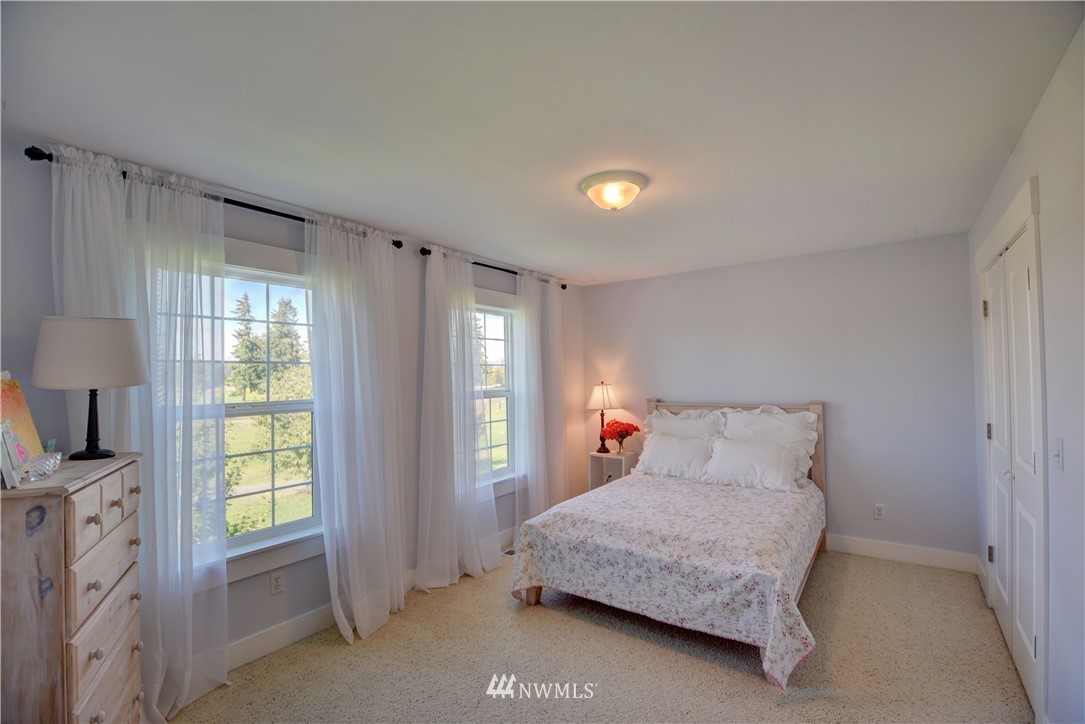 17012 Kaylen Lane Southwest Rochester, WA 98579 - Photo 16 of 26 a bedroom with a bed and a window