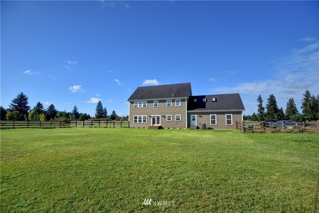 17012 Kaylen Lane Southwest Rochester, WA 98579 - Photo 24 of 26 a view of a big house with a big yard and a large trees
