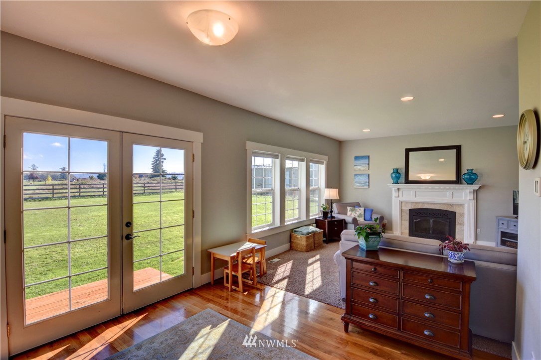 17012 Kaylen Lane Southwest Rochester, WA 98579 - Photo 4 of 26 a living room with furniture a flat screen tv and a fireplace