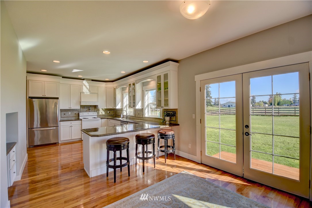 17012 Kaylen Lane Southwest Rochester, WA 98579 - Photo 5 of 26 a view of a dining room with furniture window and wooden floor